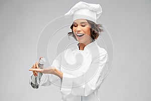 Female chef with hand sanitizer or liquid soap