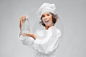 Female chef with hand sanitizer or liquid soap