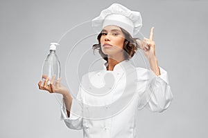 Female chef with hand sanitizer or liquid soap