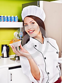 Female chef holding food.