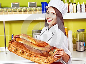 Female chef holding food.