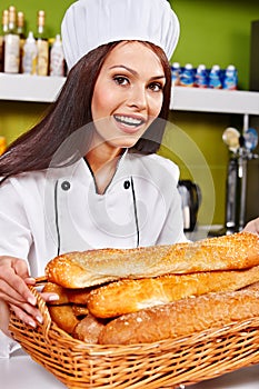 Female chef holding food.