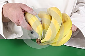 Female chef holding some banana