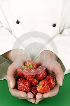 Female chef holding some strawberries