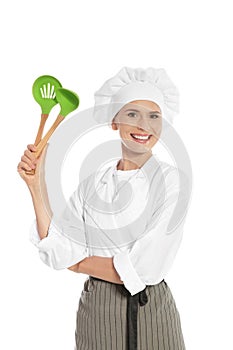 Female chef with ladle and slotted spoon
