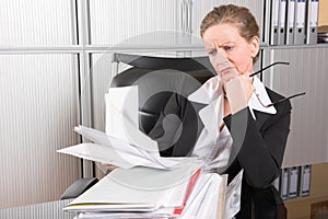 Female chef in the office with too much work