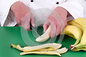 Female chef preparing a banana