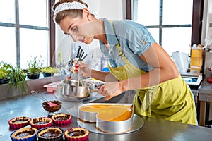 Female chef preparing cake