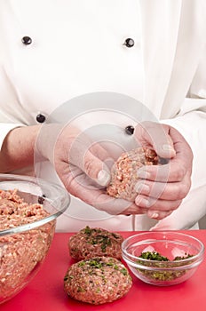 Female chef preparing meat balls