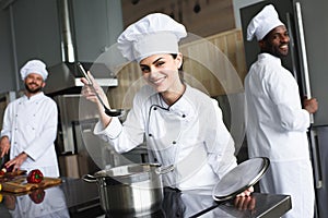 Female chef tasting dish by her