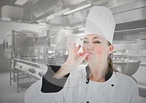 Female chef tasting food in kitchen