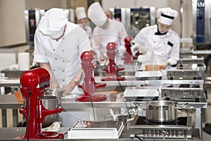 Female chefs prepare pastry in the kitchen of the hotel or restaurant.