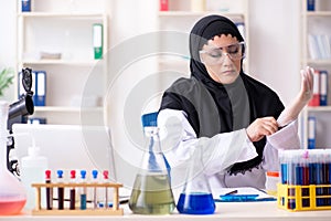 Female chemist in hijab working in the lab