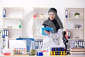 Female chemist in hijab working in the lab