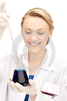 Female chemist holding bulb with chemicals