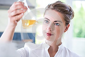 Female chemist holding flask