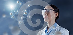 Female chemist in lab goggles contemplating a molecular structure hologram 3d illustration