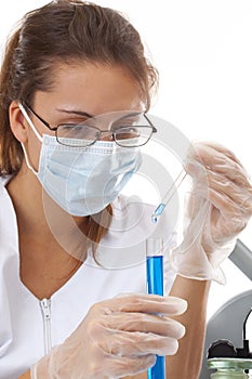 Female chemist using test tubes