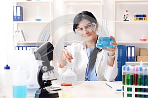 The female chemist working at the lab