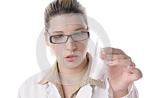 Female chemistry lab technician looks at critical