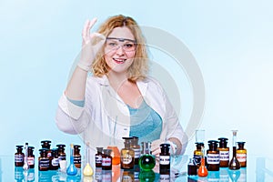 Female chemistry student with glassware test flask.