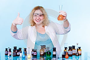 Female chemistry student with glassware test flask.