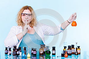 Female chemistry student with glassware test flask.