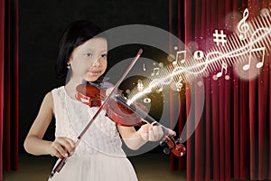 Female child playing violin on stage