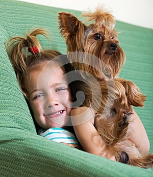 Female child playing with Yorkie