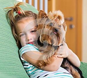 Female child playing with Yorkie