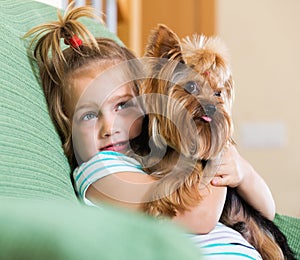 Female child playing with Yorkie