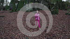 Female child running in a beech forest FDV