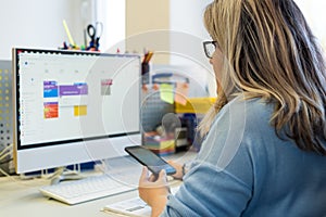 Female child therapist in an office during a phone call, using online calendar to schedule patients appointments. Calendar Planner photo