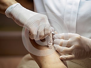 Female chiropodist working on a senior clients feet