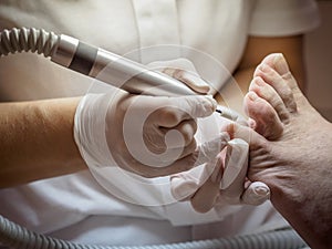 Female chiropodist working on a senior clients feet