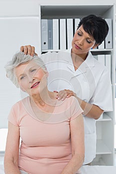 Female chiropractor doing neck adjustment