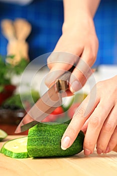 Female chopping food ingredients.