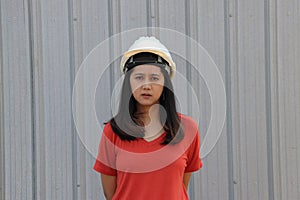 Female civil engineer wear the white helmet standing on Metal Sheet background
