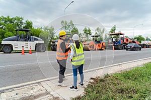 Female civil engineers consult with or with contractors to build rural roads using online technology