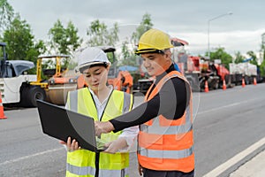 Female civil engineers consult with or with contractors to build rural roads using online technology