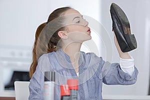 female cleaning shoes