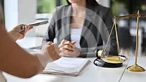 A female client tries to give a bribe to her personal lawyer to win a lawsuit