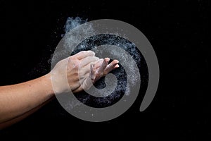 Female climber chalks her hands