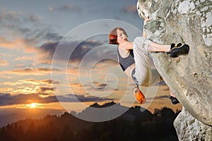 Female climber climbing without rope on a rocky wall