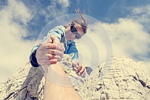 Female climber giving a helping hand.