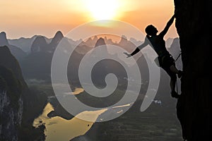 Female climber silhouette in Chinese landscape