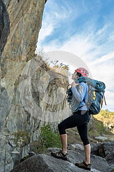 Female climber standing in front of rock