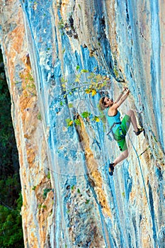 Female Climber Trying to keep Hold in last Effort to avoid deep fall down