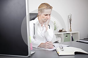Female Clinician Reading Medical Reports Seriously