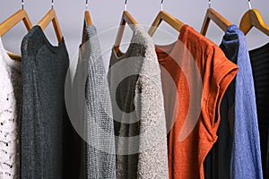 Female clothes hanging on a clothing rack in a shop or home closet photo